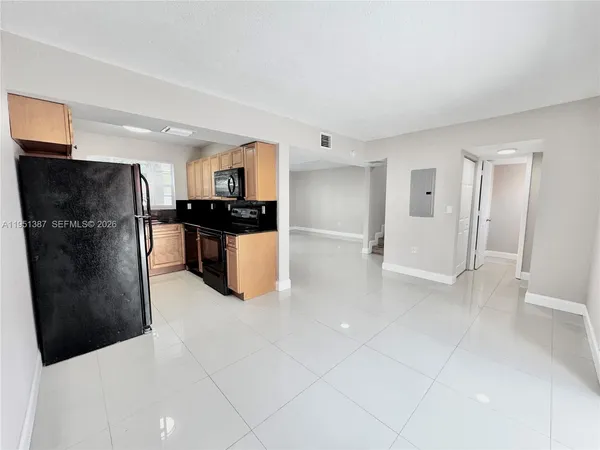 a kitchen with stainless steel appliances a refrigerator a sink a stove and cabinets