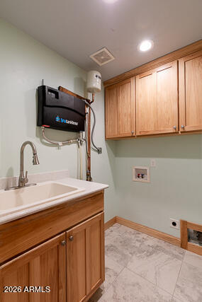 6233 West Airport Road Willcox, AZ 85643 - Photo 24 of 54 a kitchen with a sink cabinets and appliances
