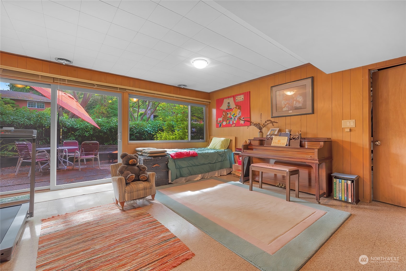4630 View Drive Everett, WA 98203 - Photo 27 of 40 a living room with furniture a flat screen tv and a floor to ceiling window