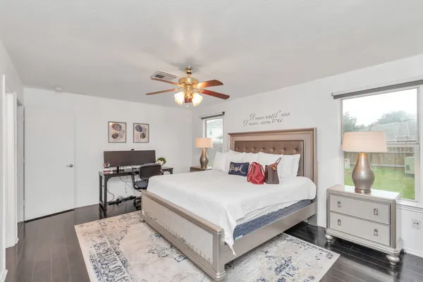 a bedroom with a large bed and a chandelier