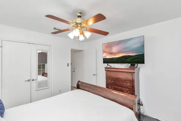 a bedroom with a bed and a flat screen tv