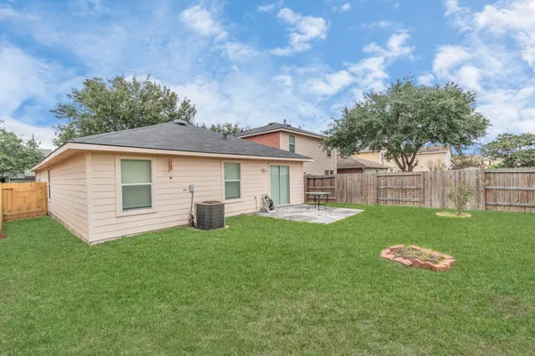 a view of a house with a yard and sitting area