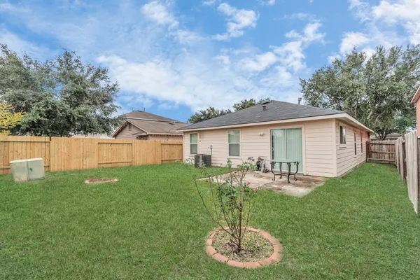 a backyard of a house with table and chairs