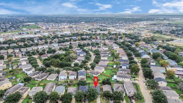 an aerial view of residential building with green space