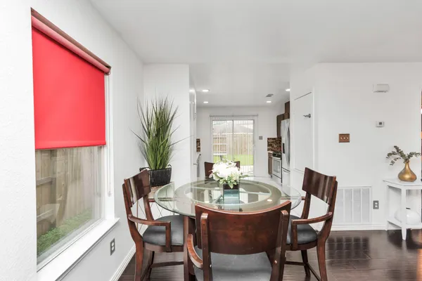 a dining room with furniture and wooden floor