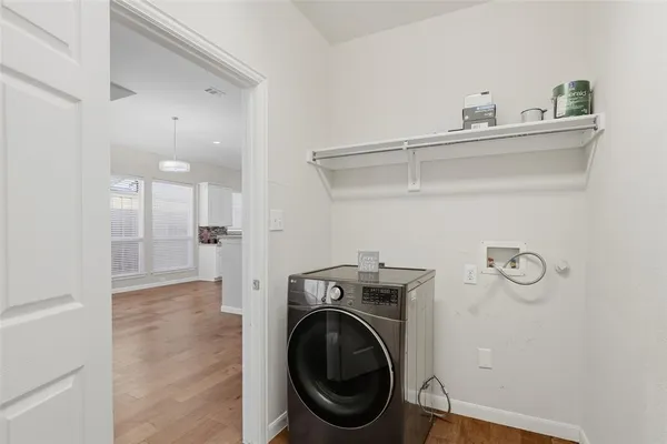 a view of a hallway with washer and dryer
