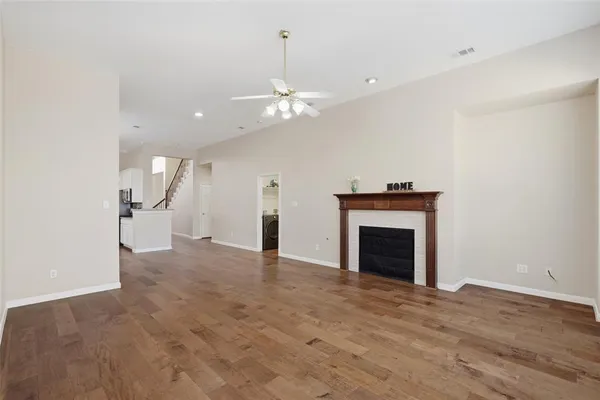 a view of an empty room with a fireplace