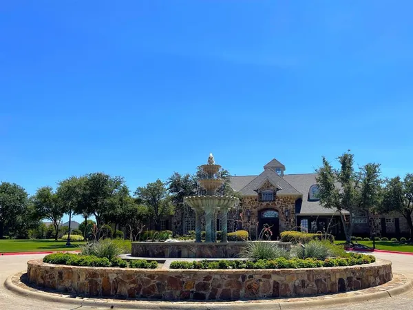 a view of a park with iron fence