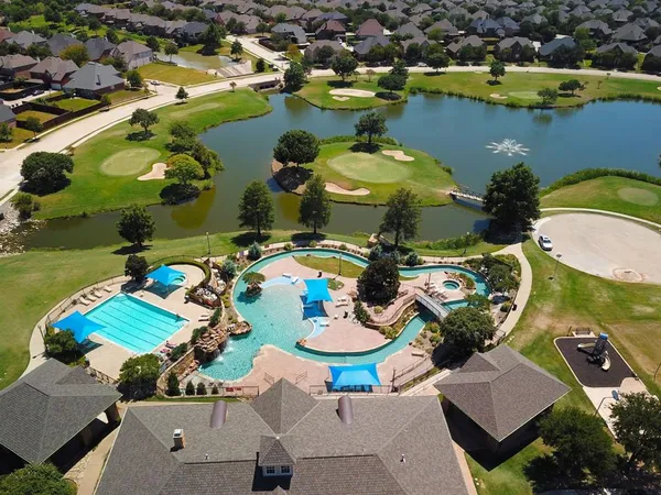 an aerial view of a house with a swimming pool yard and outdoor seating