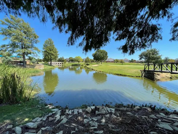 a view of a lake with a house in the background