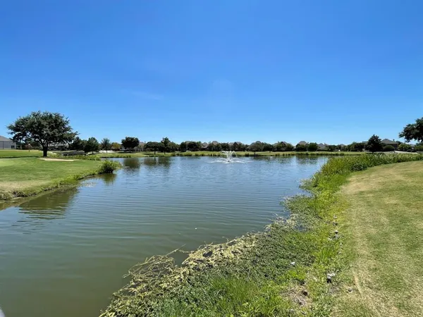 a view of yard with swimming pool and trees in the background
