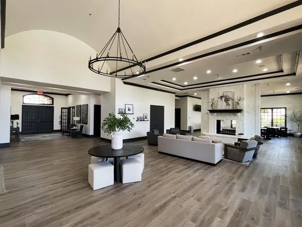 a living room with fireplace furniture and a large window