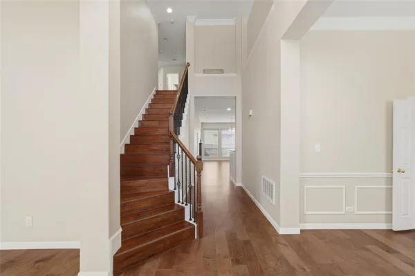 a view of entryway and hall with wooden floor