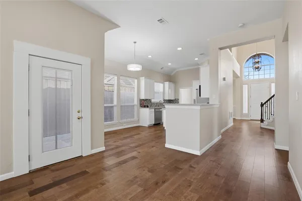 a view of a kitchen with furniture and wooden floor