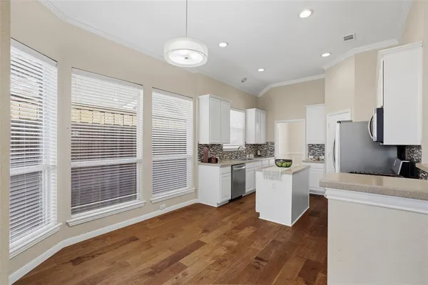 a kitchen with a sink a counter top space and appliances