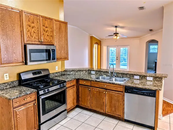 a kitchen with stainless steel appliances granite countertop a stove and a microwave