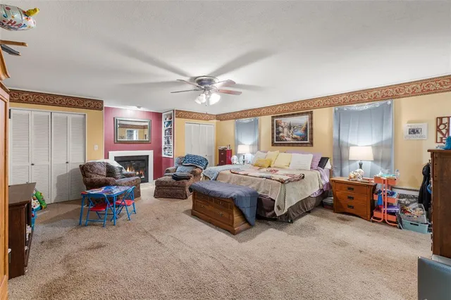 a bedroom with a bed couch and a window