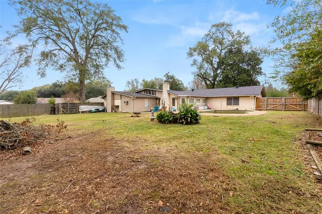a front view of house with yard and trees
