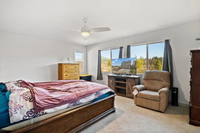 a bedroom with a bed couch and window
