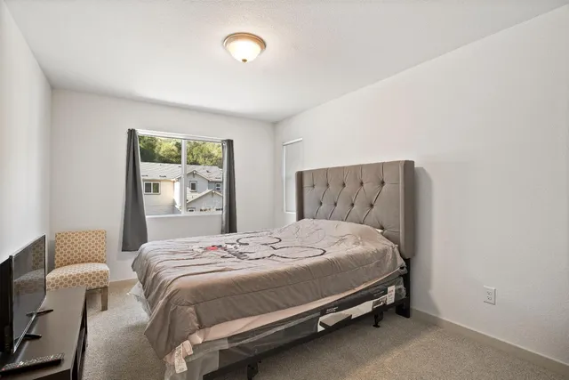 a bedroom with a bed and chair