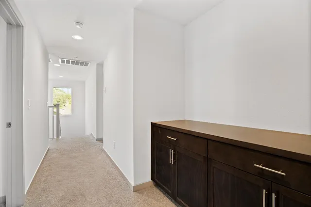 a view of hallway with wooden floor