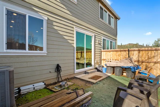 a view of a patio with table and chairs with wooden floor and fence