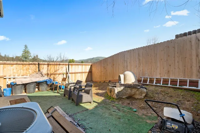 a view of a house with backyard porch and furniture