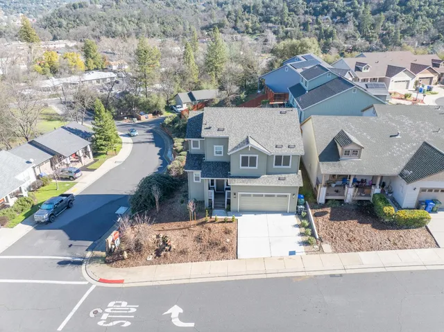 an aerial view of a house with a yard