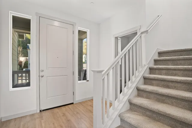 a view of staircase with white walls and a window