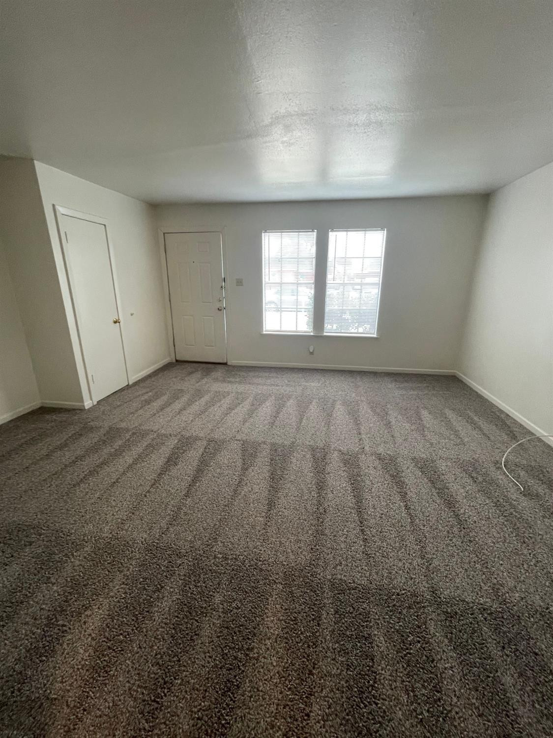 2121 33rd Street, Unit A Lubbock, TX 79411 - Photo 2 of 6 an empty room with windows