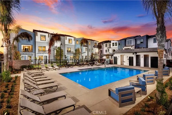 a view of a swimming pool with outdoor seating