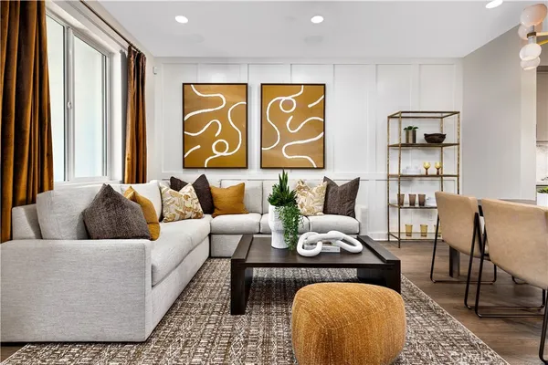 a living room with furniture and painting on the wall
