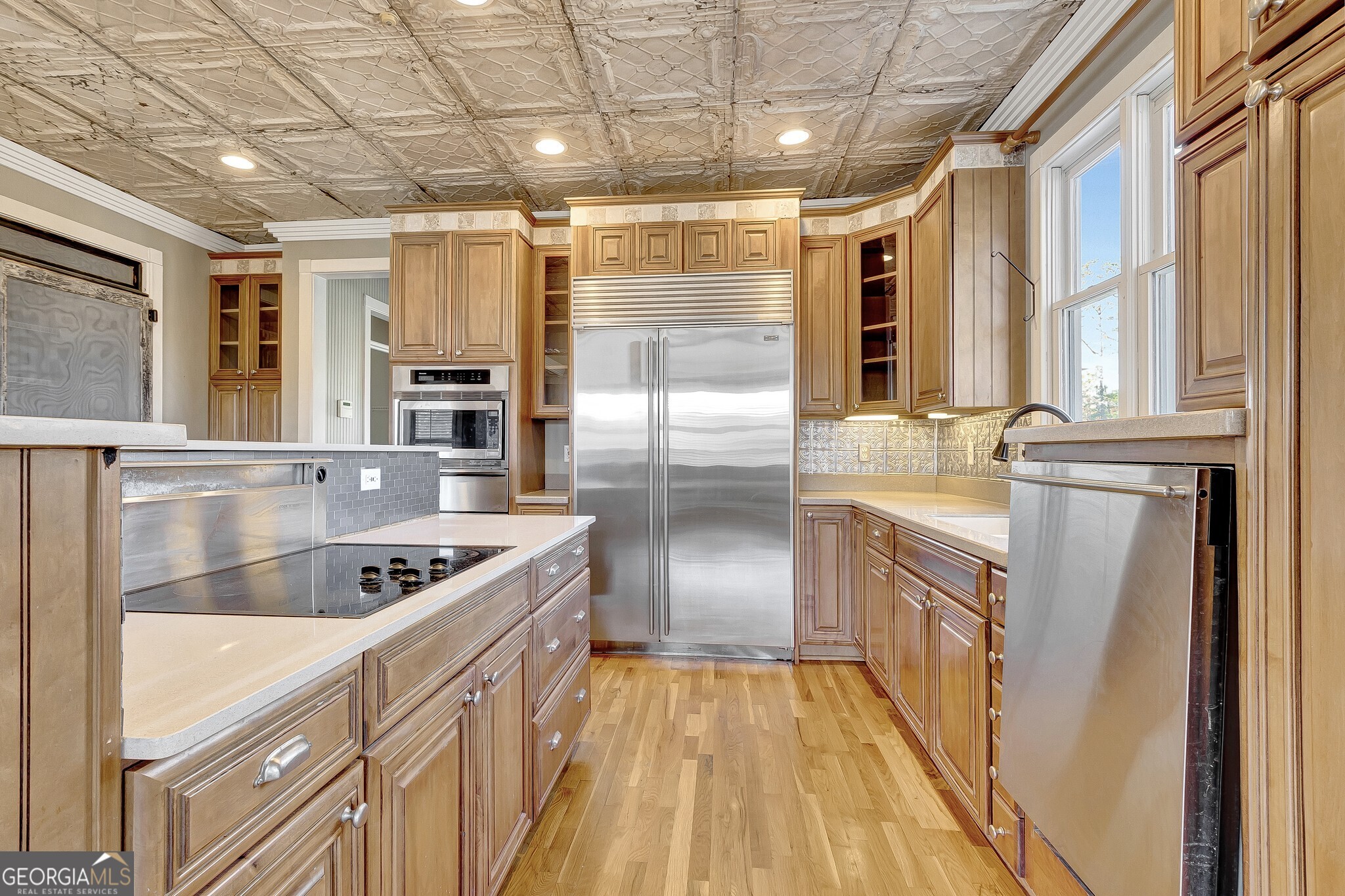220 Joe Roberts Road Newnan, GA 30263 - Photo 40 of 108 a kitchen with stainless steel appliances granite countertop a sink and a refrigerator