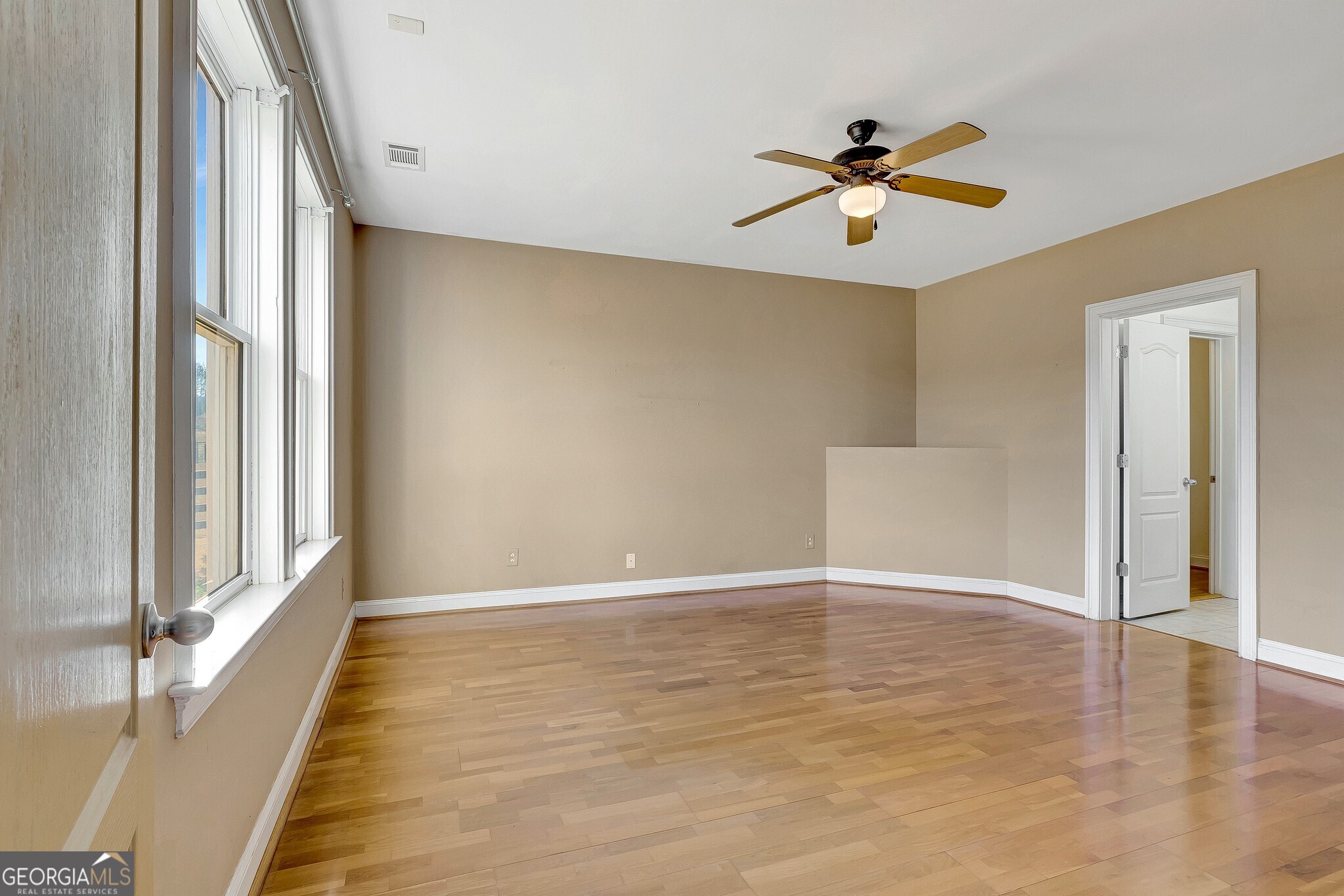 220 Joe Roberts Road Newnan, GA 30263 - Photo 71 of 108 a view of an empty room with wooden floor and a window