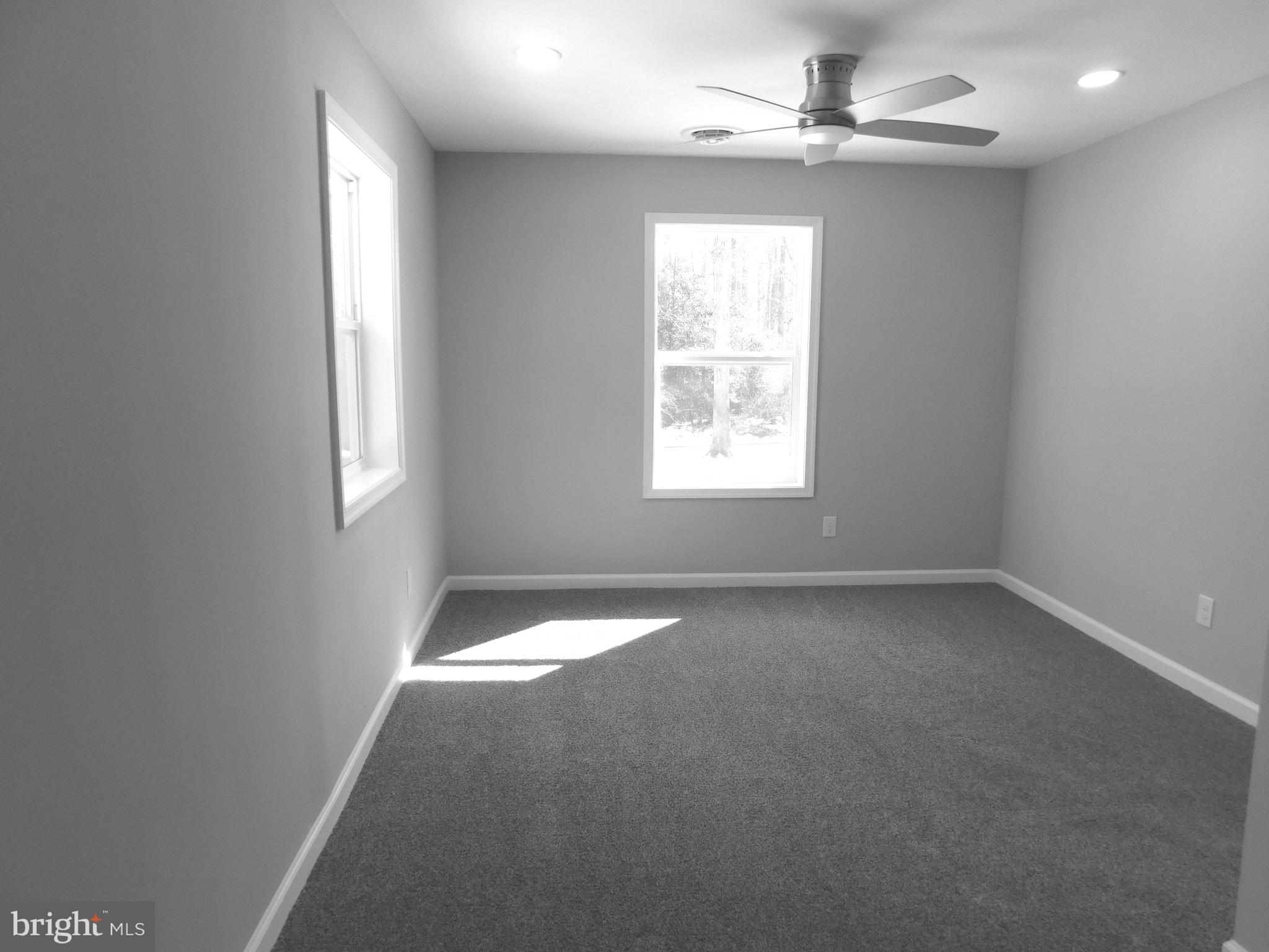 9458 Benson Road Lincoln, DE 19960 - Photo 19 of 38 an empty room with a window and a fan