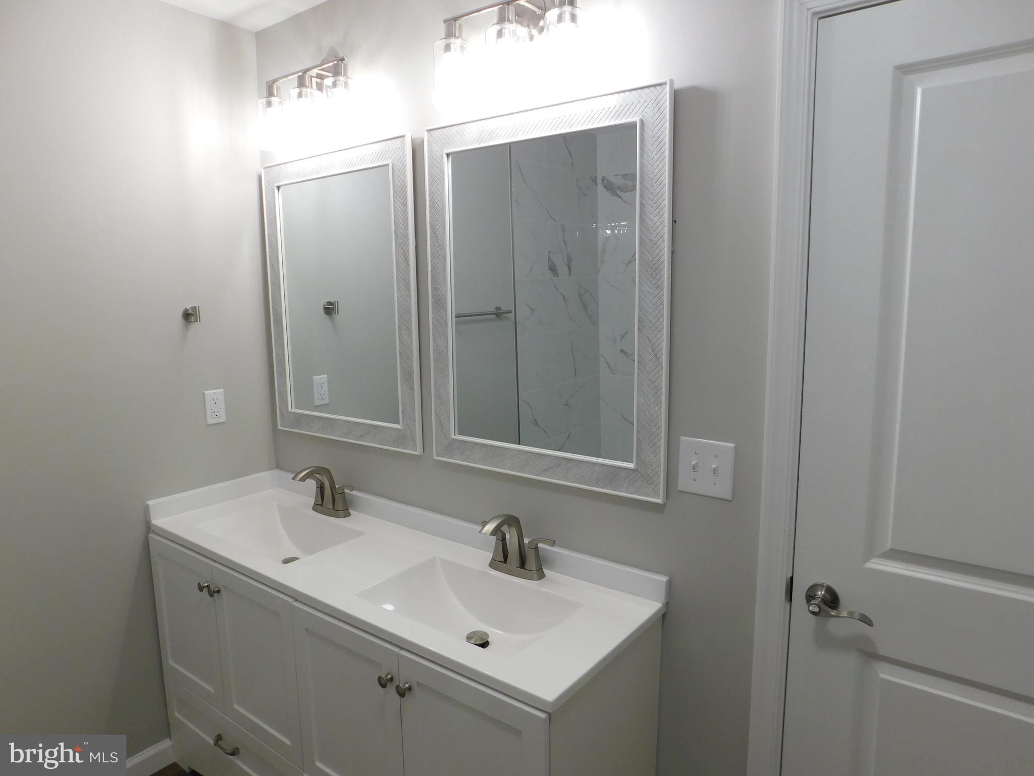 9458 Benson Road Lincoln, DE 19960 - Photo 23 of 38 a bathroom with a sink and mirror