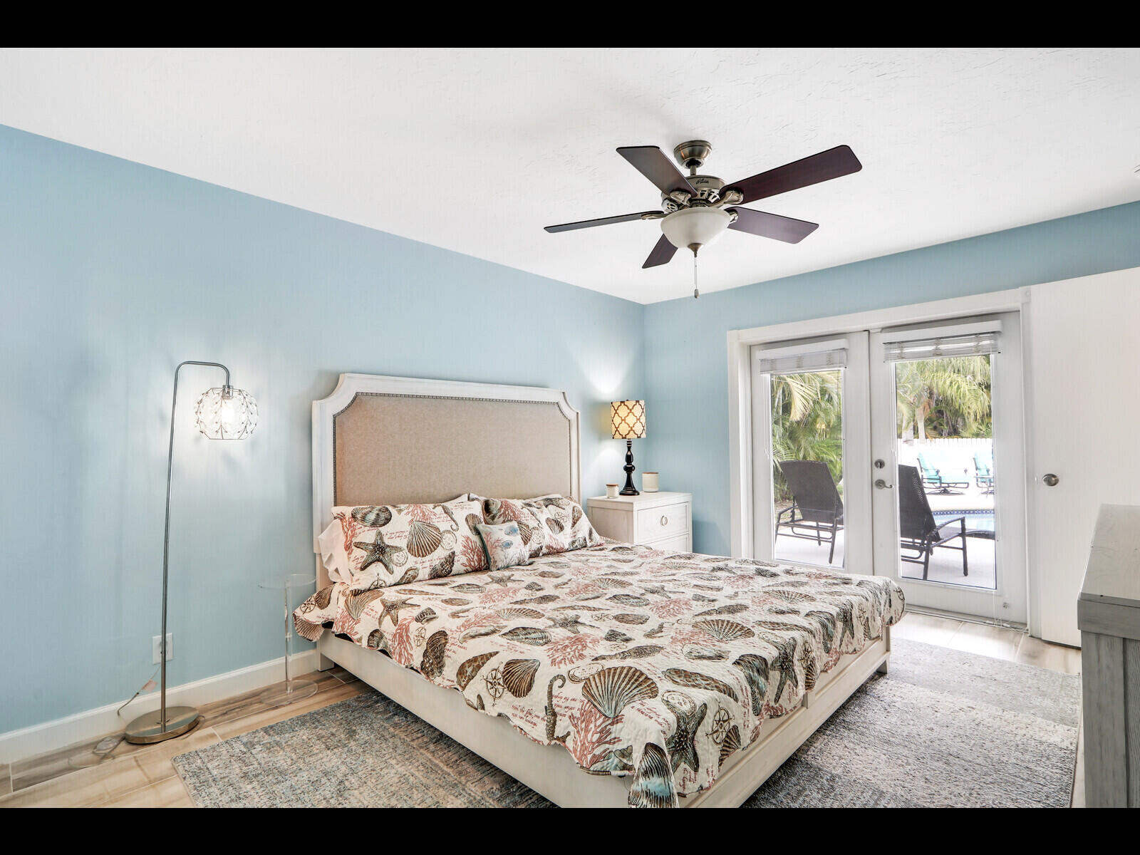 609 Oak Terrace Jupiter, FL 33458 - Photo 19 of 28 a bedroom with a bed and a large window