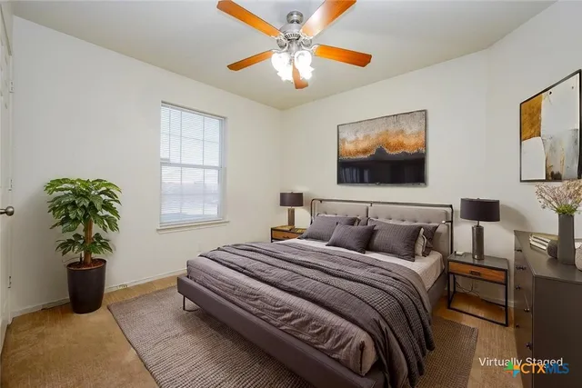 a bedroom with a bed and a potted plant