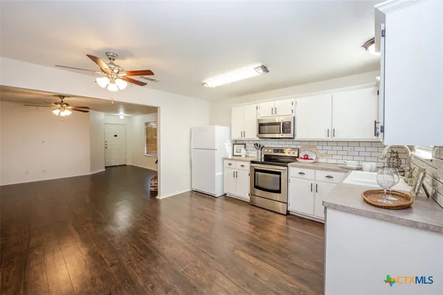 a kitchen with granite countertop stainless steel appliances and wooden cabinets