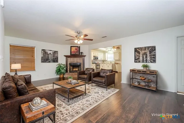a living room with furniture and a fireplace