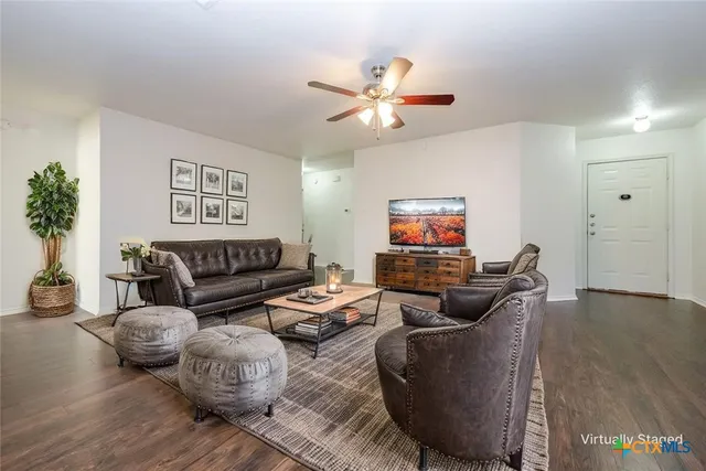 a living room with furniture and a flat screen tv