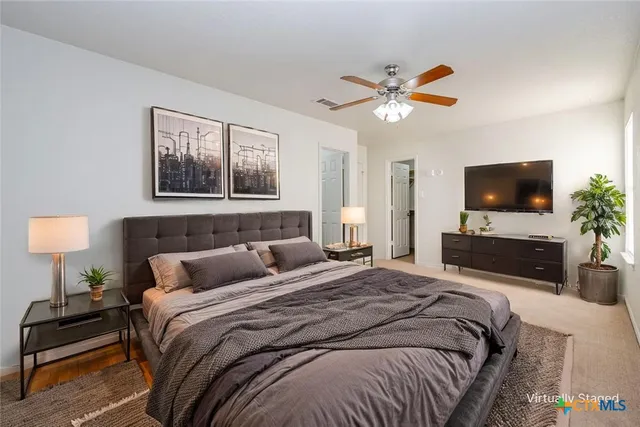 a bedroom with a bed and a flat screen tv