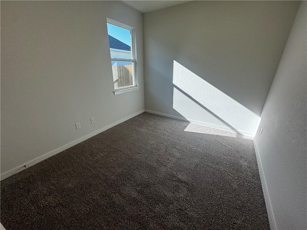 4795 Holm Oak Road Bryan, TX 77845 - Photo 11 of 17 Empty room with carpet and baseboards