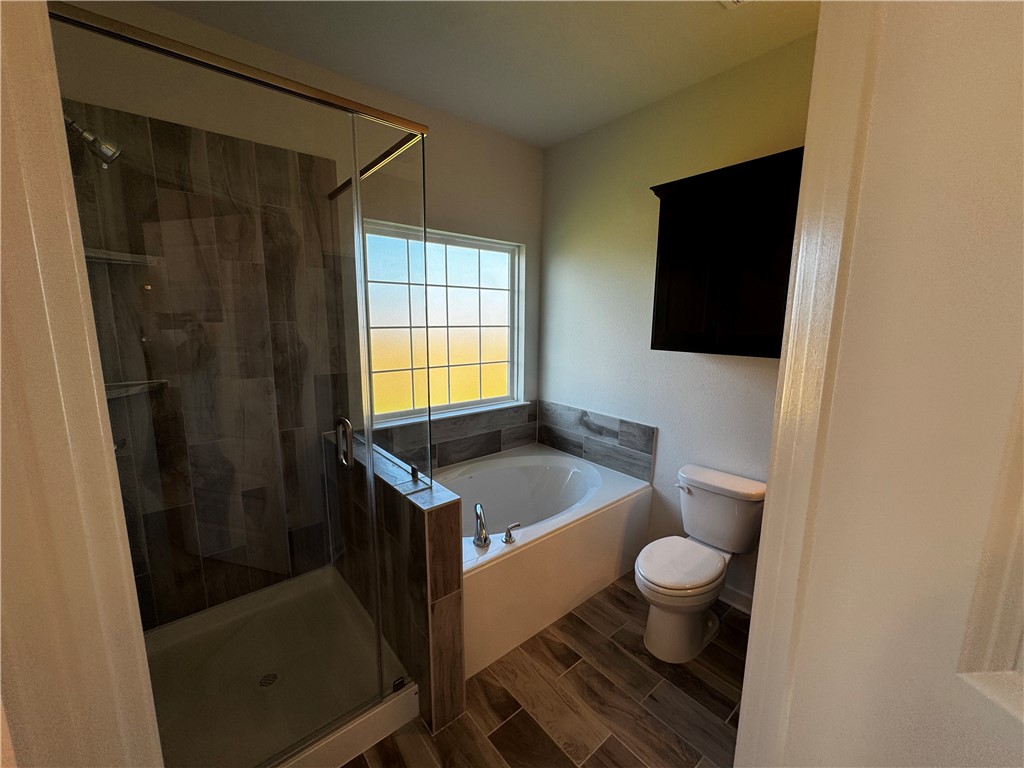 4795 Holm Oak Road Bryan, TX 77845 - Photo 14 of 17 Full bathroom featuring a stall shower, wood finish floors, and a bath