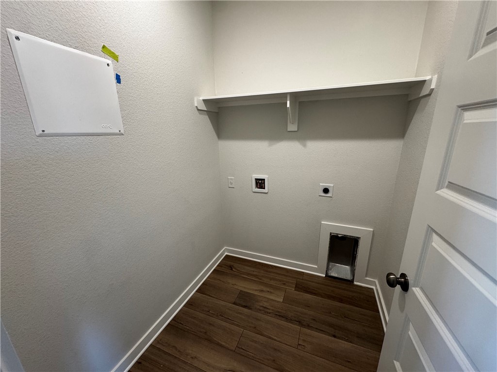 4795 Holm Oak Road Bryan, TX 77845 - Photo 17 of 17 Laundry area with dark wood finished floors, hookup for an electric dryer, hookup for a washing machine, and a textured wall