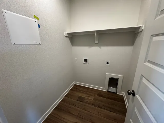 a view of storage and utility room with wooden floor