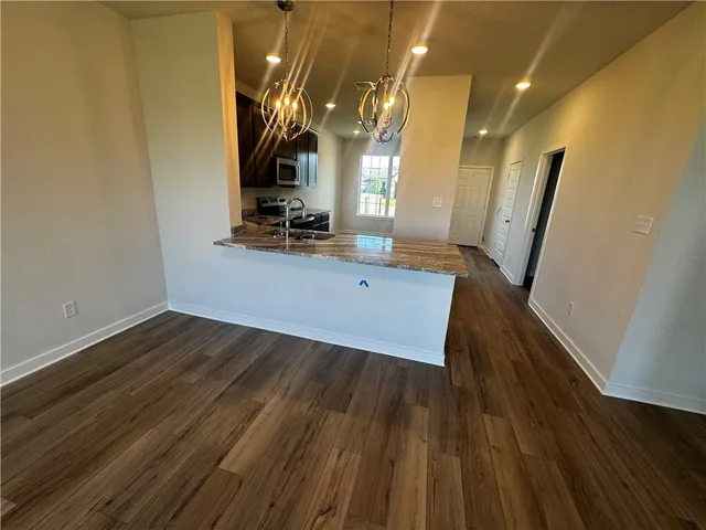 a view of a living room with wooden floor