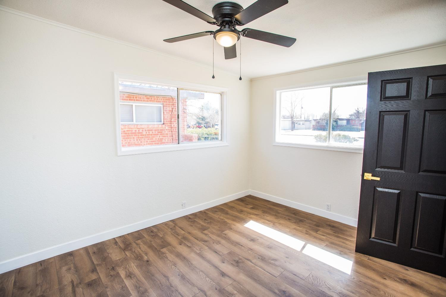 2728 66th Street Lubbock, TX 79413 - Photo 15 of 22 a view of empty room with wooden floor and fan