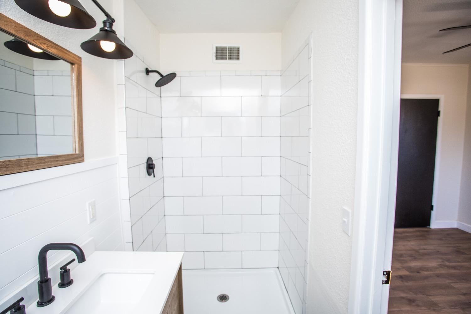 2728 66th Street Lubbock, TX 79413 - Photo 17 of 22 a bathroom with a sink and shower