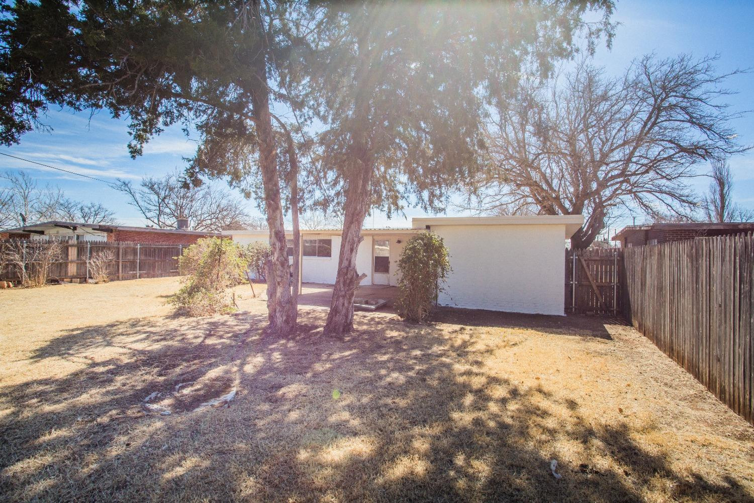 2728 66th Street Lubbock, TX 79413 - Photo 22 of 22 a view of backyard with tree